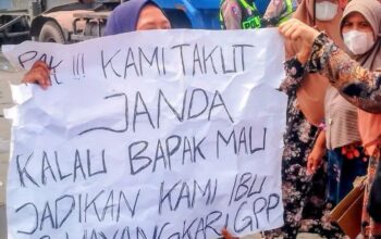 Warga Bagan Deli membawa poster protes saat unjuk rasa di Polres Pelabuhan Belawan